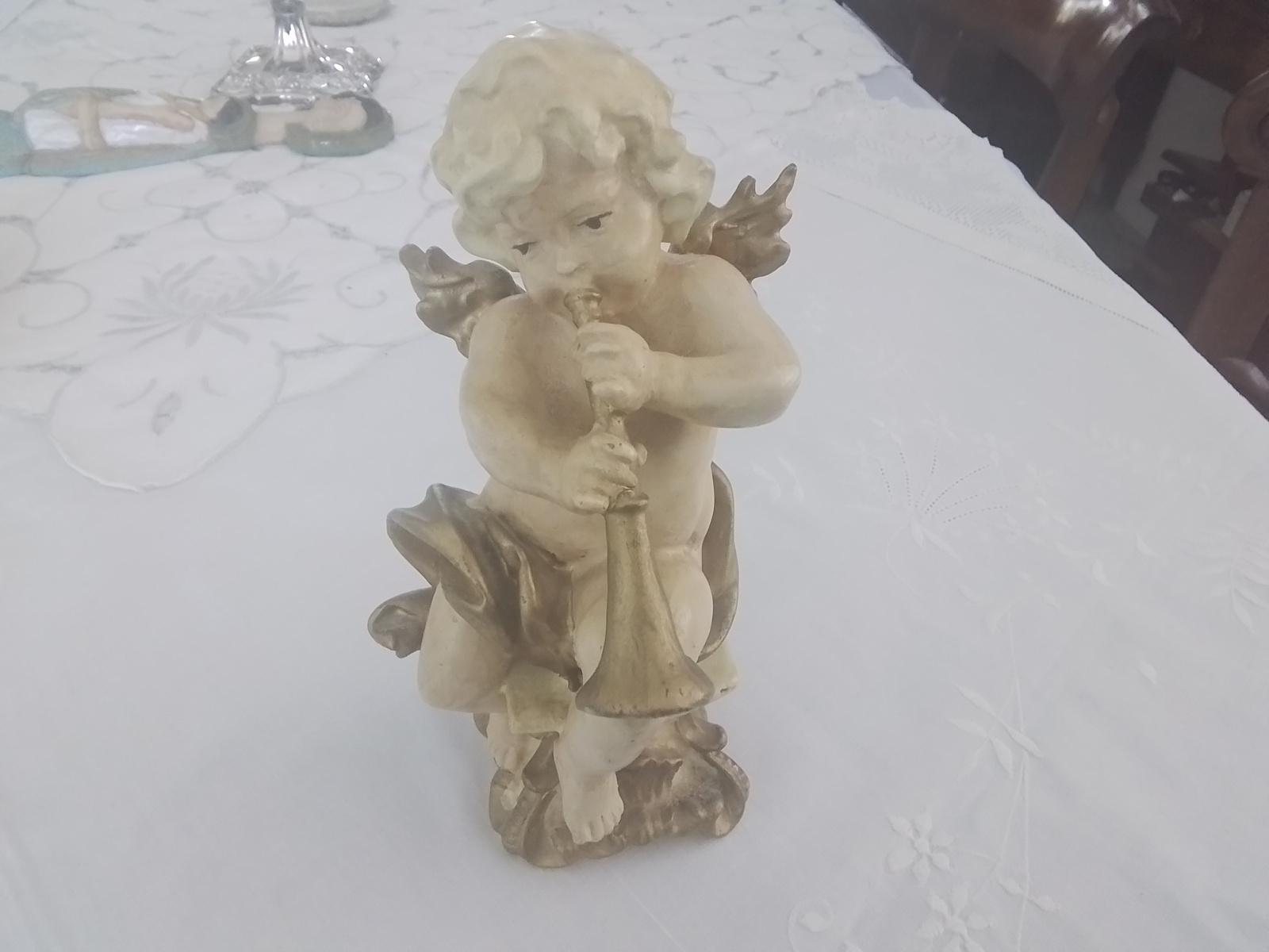 Beeldje van cupido met hoorn  of trompet.